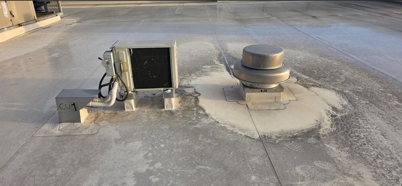 Rooftop HVAC condensing unit installed on a custom-fabricated steel stand with full membrane flashing, Houston commercial building